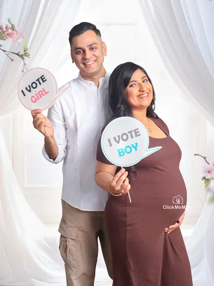 Boy or girl? The happy anticipation is a joy to capture. This couple brought these fun "I vote boy" and "I vote girl" props to their session, adding a playful touch to their pregnancy announcement photos.