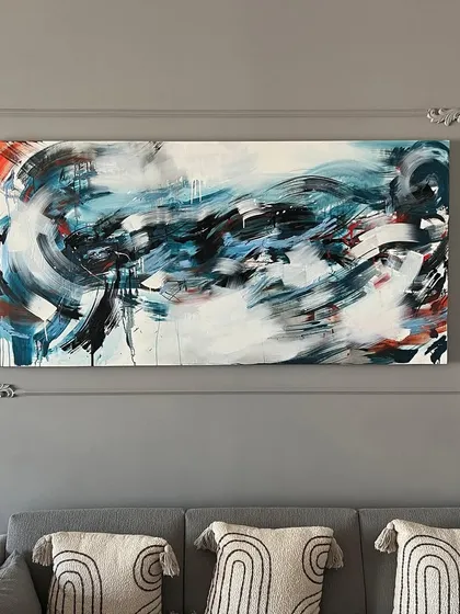 This large-scale abstract painting was created to be the centerpiece of a modern living room. The dynamic swirls of blue, black, and white are all about capturing energy and movement on canvas.