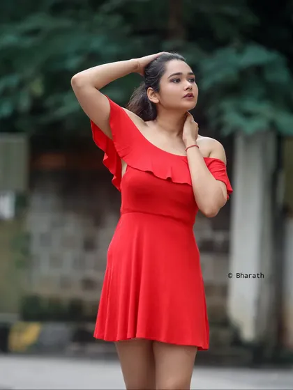 A three-quarter shot capturing a candid moment. The pose is natural and shows off the flattering silhouette of the A-line dress.