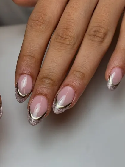 A glamorous take on the French manicure. This design features a cat-eye glitter base for the tips, outlined with a sharp, elegant chrome line for a truly luxurious feel.