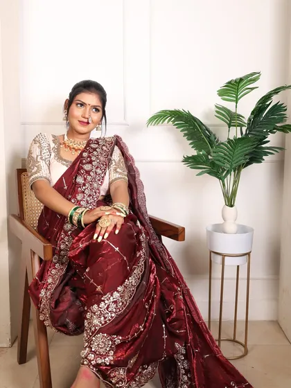 A relaxed, seated pose showing how the Nauvari drapes elegantly even when sitting.
