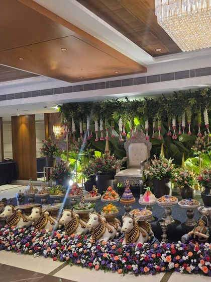 A wider view of the greenery wall stage, showing the full offering table.