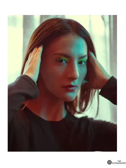 An experimental portrait using a mix of green and warm light. This technique creates a unique, futuristic mood perfect for an edgy portfolio.