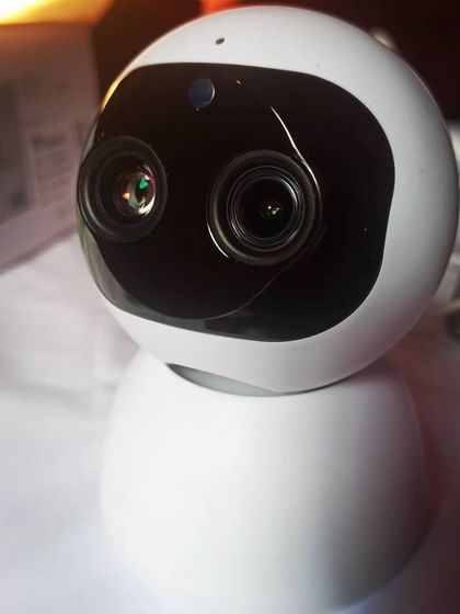 A clear, front-on shot of the CareCam AI HD IP intelligent network camera, showing its dual-lens system.