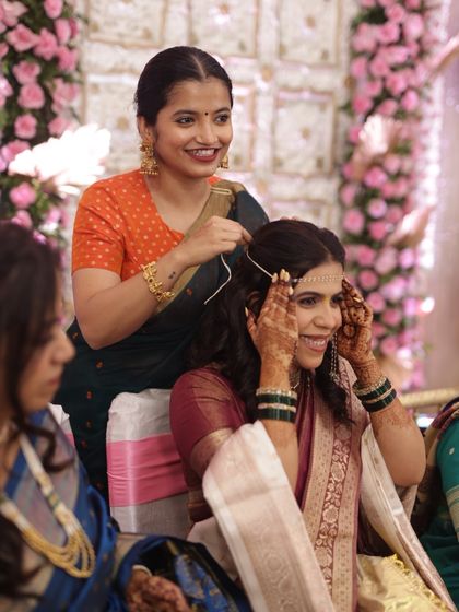 A candid moment from a wedding, where the bride's subtle and elegant mehendi is visible.