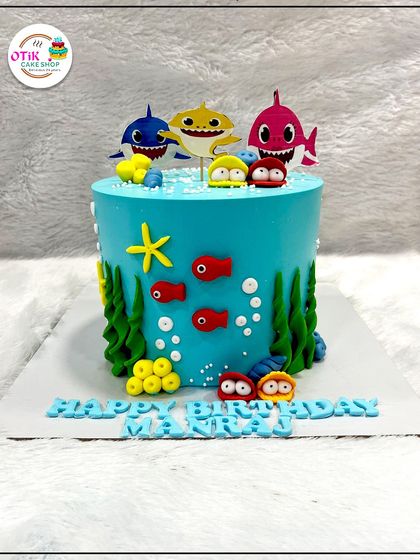 Doo doo doo! This Baby Shark cake is sure to be a hit. We created an underwater scene with fondant seaweed, fish, and the whole shark family swimming around a bright blue cake.