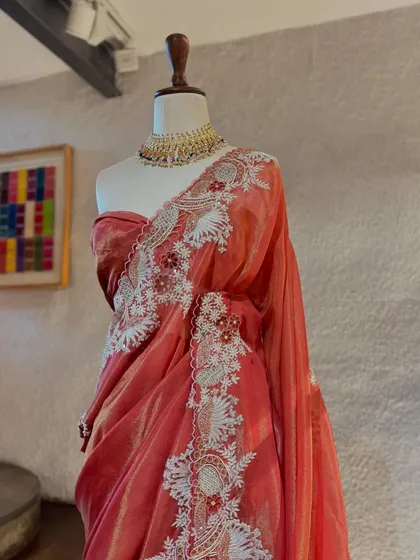 This organza saree by Jaya Rathore is a work of art, with its wide, intricate white embroidery creating a bold and beautiful statement.