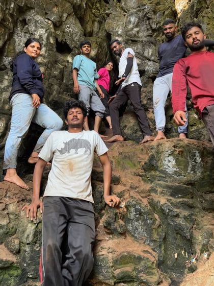 A group posing inside a cave, showing the rugged and adventurous nature of the trip.