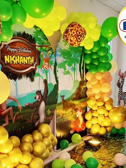 A vibrant Jungle Book theme with a full character backdrop and a lush green and yellow balloon garland.