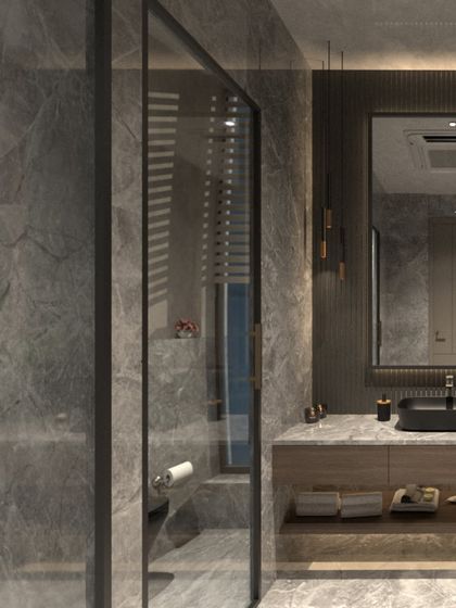 This angle shows the glass shower enclosure and the continuation of the grey stone, creating an unbroken and spacious feel in the bathroom.