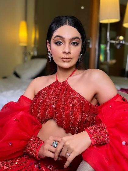 An indoor shot that highlights the intricate sequin work on the blouse.