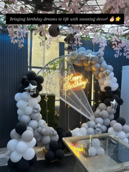 Bringing birthday dreams to life with stunning decor. This image shows the setup ready for the party, with the neon sign glowing and the balloons perfectly placed.
