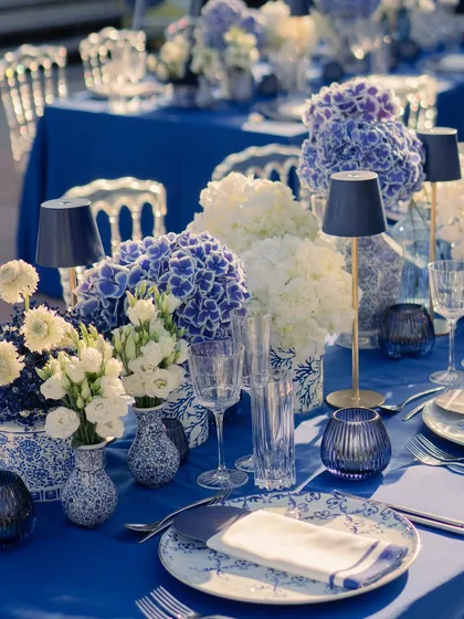 This tablescape for a welcome lunch in Cannes was inspired by the Mediterranean. I used classic blue and white porcelain, lush hydrangeas, and elegant table lamps to create a chic, seaside dining experience.