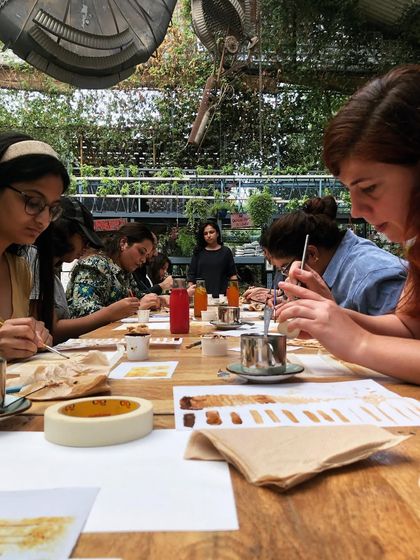 A group of participants deeply engaged in their coffee painting. The focus and calm in the room is always palpable during these sessions.