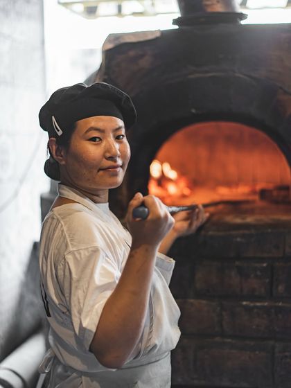 Our chef, ready at the oven. We bring not just the equipment but also the skilled team needed to execute a flawless live pizza experience for your guests.