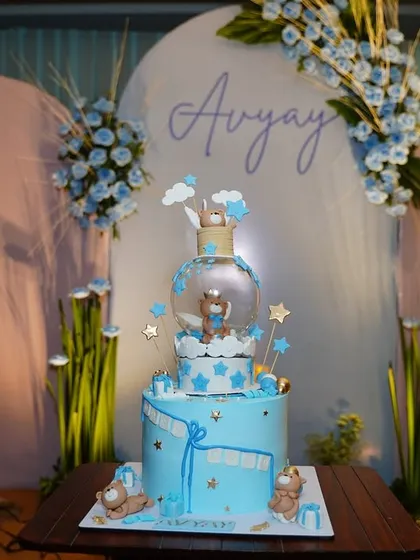 The incredible, multi tiered cake for Avyay's celebration, perfectly matching the blue and white teddy bear theme. Our backdrops are designed to make moments like the cake cutting even more special.