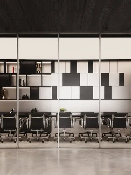 A modern conference room for AU Real Estate, viewed through a full-height glass partition. The design features a striking black-and-white storage wall and minimalist detailing, emphasizing a clean and professional aesthetic.