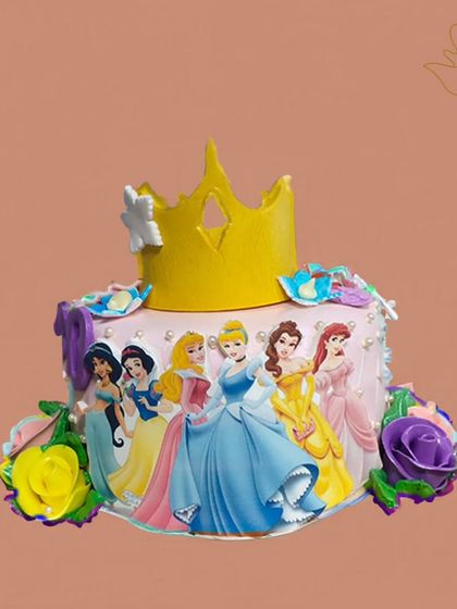 A royal gathering of Disney princesses on one cake. This design features Cinderella, Belle, and others, topped with a golden crown and surrounded by colorful roses.