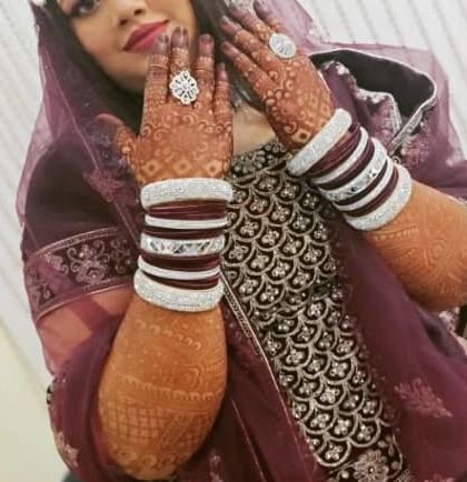 This bride is showcasing her stunning dark henna stain along with her beautiful bangles. The color is rich and perfect for her wedding look.