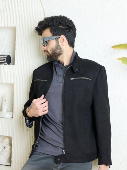 A close-up of the black biker jacket, emphasizing its clean lines and the quality of the wool-blend fabric. This is a statement of impeccable taste.