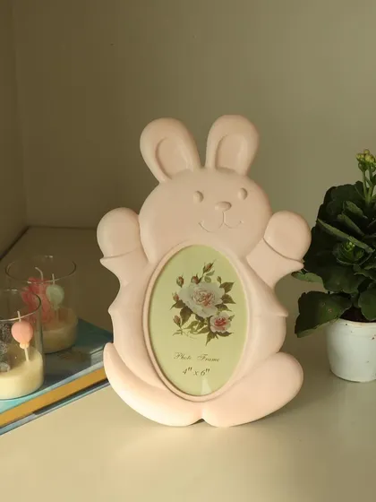 Our adorable bunny photo frame, shown here in a soft pink. This playful and charming piece is designed to bring a smile to your face every time you see it.