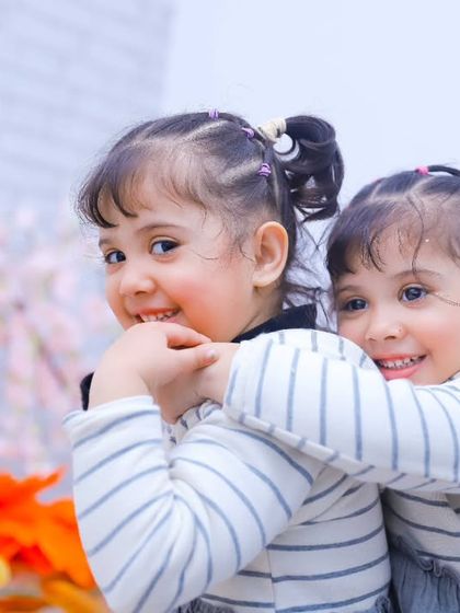 A playful piggyback hug between two sisters. Our sessions are full of fun and games to bring out the most genuine smiles.