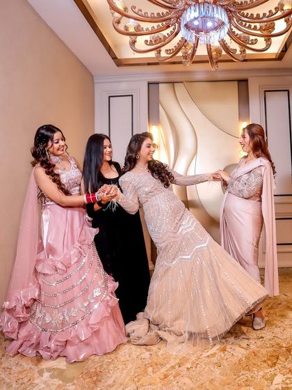 A fun and candid moment between the bride and her bridesmaids. This photo perfectly captures the joy and support of sisterhood, a precious memory from the wedding day.
