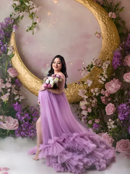 A fairytale moment. Our crescent moon set, surrounded by a cloud of purple and pink flowers, provides a magical backdrop for this beautiful maternity portrait.