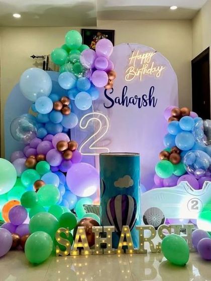 A hot air balloon themed party with marquee letters and a pastel balloon arrangement.