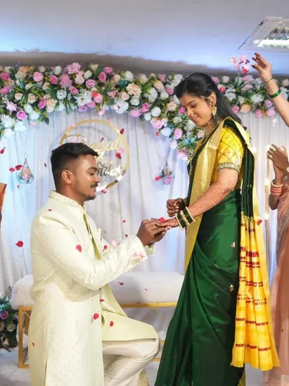 A candid moment during the ring ceremony, with friends showering the couple with petals. Our decor provides a stunning setting for these unforgettable memories.