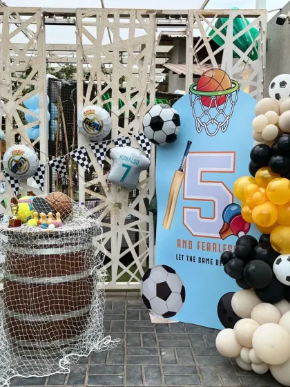 A duplicate image of the sports-themed cake table, highlighting the creative use of a barrel and netting to fit the theme.