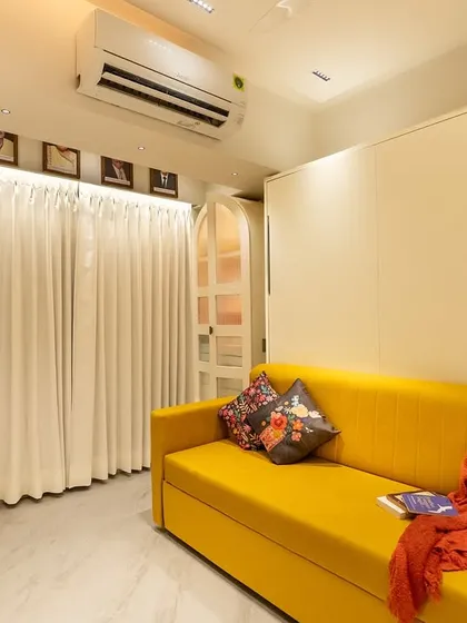 With the wall bed folded up, the room transforms into a cozy living area or office space. This is the kind of smart, flexible design we love to create for our clients.