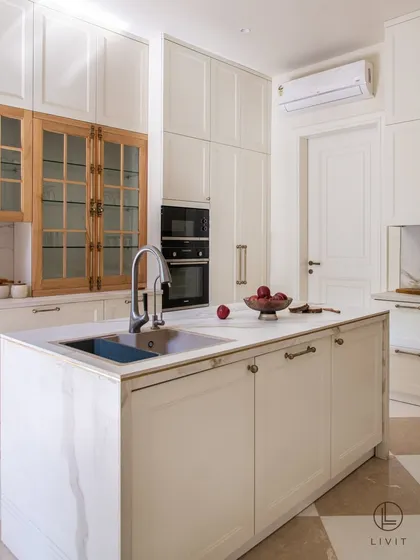 A well-appointed kitchen is the heart of the home, and its details matter. In this stunning residence, our Sphere cabinet pulls and Cremone bolts in an Antique Brass matte finish provide a warm, metallic counterpoint to the clean white cabinetry and natural wood. It is a testament to how the right hardware can elevate a space from functional to exceptional.