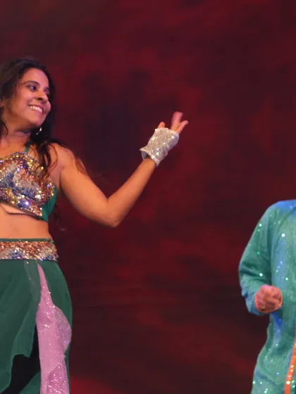 A smile shared on stage. This captures the joy and camaraderie that is at the heart of all our performances at Tarang.