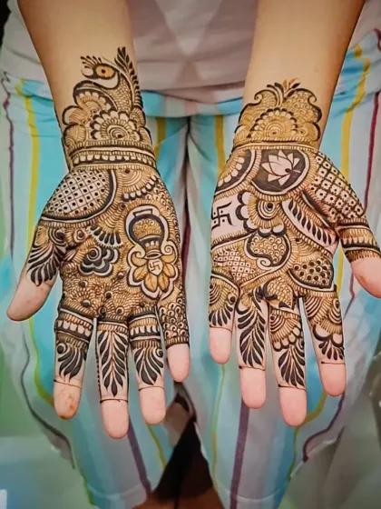 Festive mehandi designed for a special celebration. This custom piece includes auspicious symbols like a kalash (ceremonial pot) and a swastika, blended with traditional peacock and floral patterns.