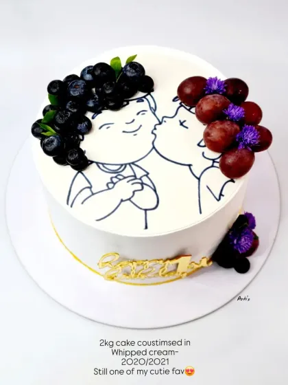 A creative and cute anniversary cake from 2020, using fresh grapes to create the "hair" for the illustrated couple.