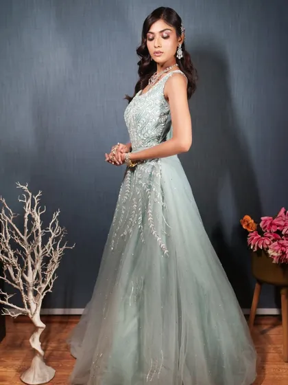 A side view of the mint green gown, highlighting the intricate work on the bodice.