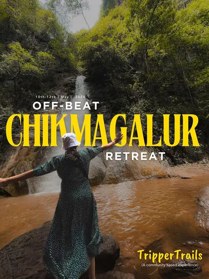 An off-beat Chikmagalur retreat. A woman stands with open arms before a waterfall, embracing the raw beauty of nature on one of my specially curated trips.