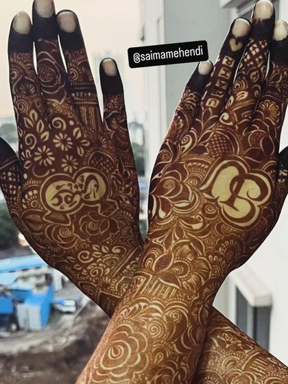 A beautiful example of symmetrical personalization, with the initials 'S' and 'B' placed in matching positions on each hand.