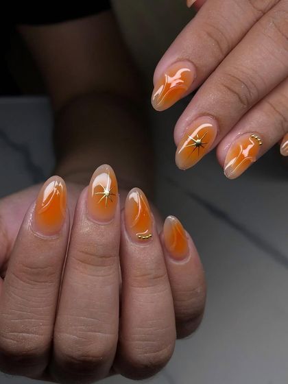 A warm, amber-colored set with a translucent finish and delicate, spider-like gold star accents.