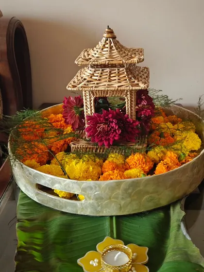 A beautiful centerpiece with marigolds and a miniature bamboo structure, adding a unique touch to the Diwali decor.