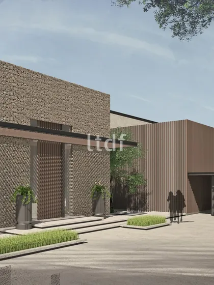 This design explores the beauty of rugged textures in a modern context. The extensive use of stone cladding on the facade creates a powerful, almost monolithic presence, balanced by the clean lines of the contemporary architectural form.