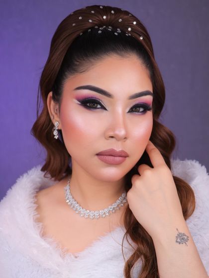 Dive into a world of glam and creativity with this purple and pink graphic eye makeup. The white liner detail adds a futuristic touch, perfect for a creative portfolio.