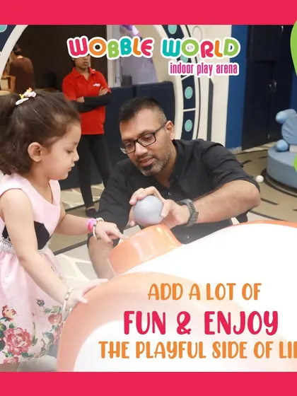 A father and daughter share a playful moment. We love providing a space where families can connect and enjoy quality time together.