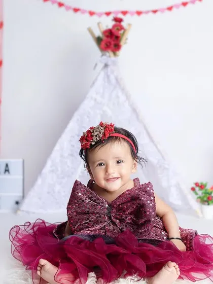 Myra turns six months! This beautiful maroon dress and heart-themed teepee setup is perfect for a half-birthday celebration.