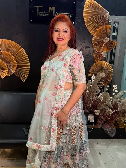 A full-length shot of the mom in her floral lehenga, looking absolutely stunning.