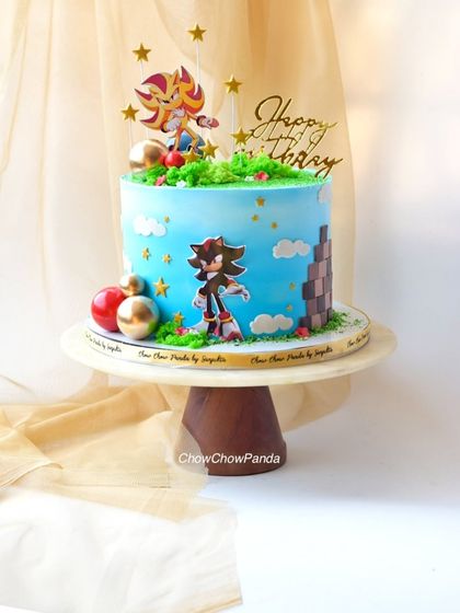 A slightly different perspective of the Choco Mousse Sonic cake, highlighting the "Happy Birthday" topper and star decorations.