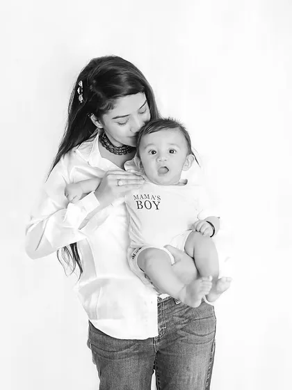 A sweet kiss for her baby boy. This timeless black and white photo is a simple and powerful expression of a mother's love and affection.