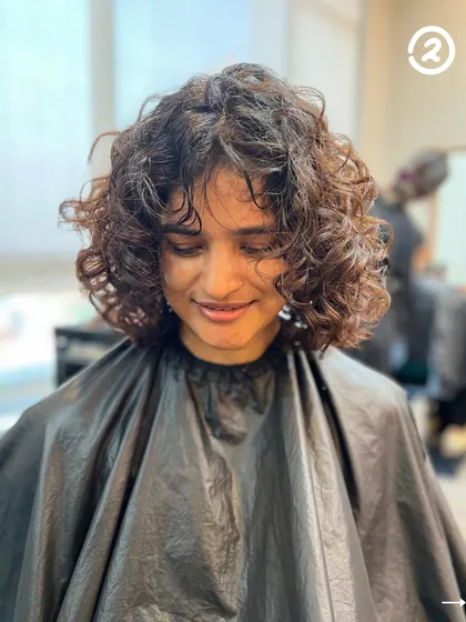 A soft, curly bob with a fringe is such a cool look. This cut is all about creating shape and volume while letting the natural texture shine.