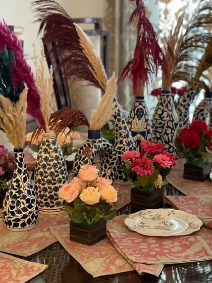 Amp up your table game with a perfect blend of style and class. This setup features bold, patterned vases, colorful pampas grass, and small floral arrangements to make every piece gazeworthy.